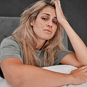 Depression Tired And Portrait Of A Sick Woman Sitting On The Bed In