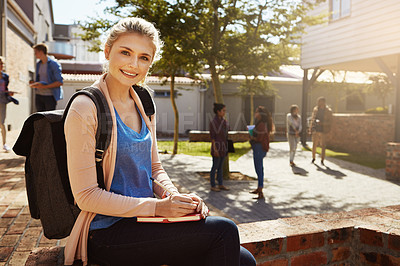 Buy stock photo Portrait of a student studying on campus with other students blurred in the background