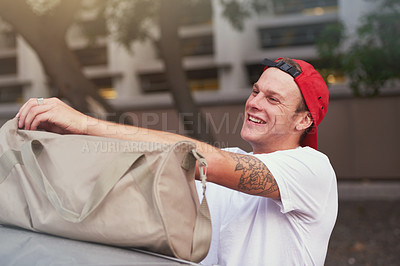 Buy stock photo Shot of a young man opening his tog bag