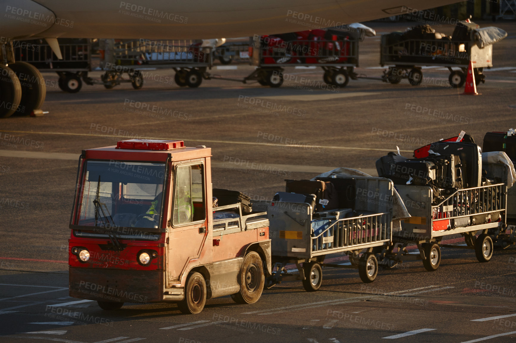 Buy stock photo Shot of luggage being taken to the plane