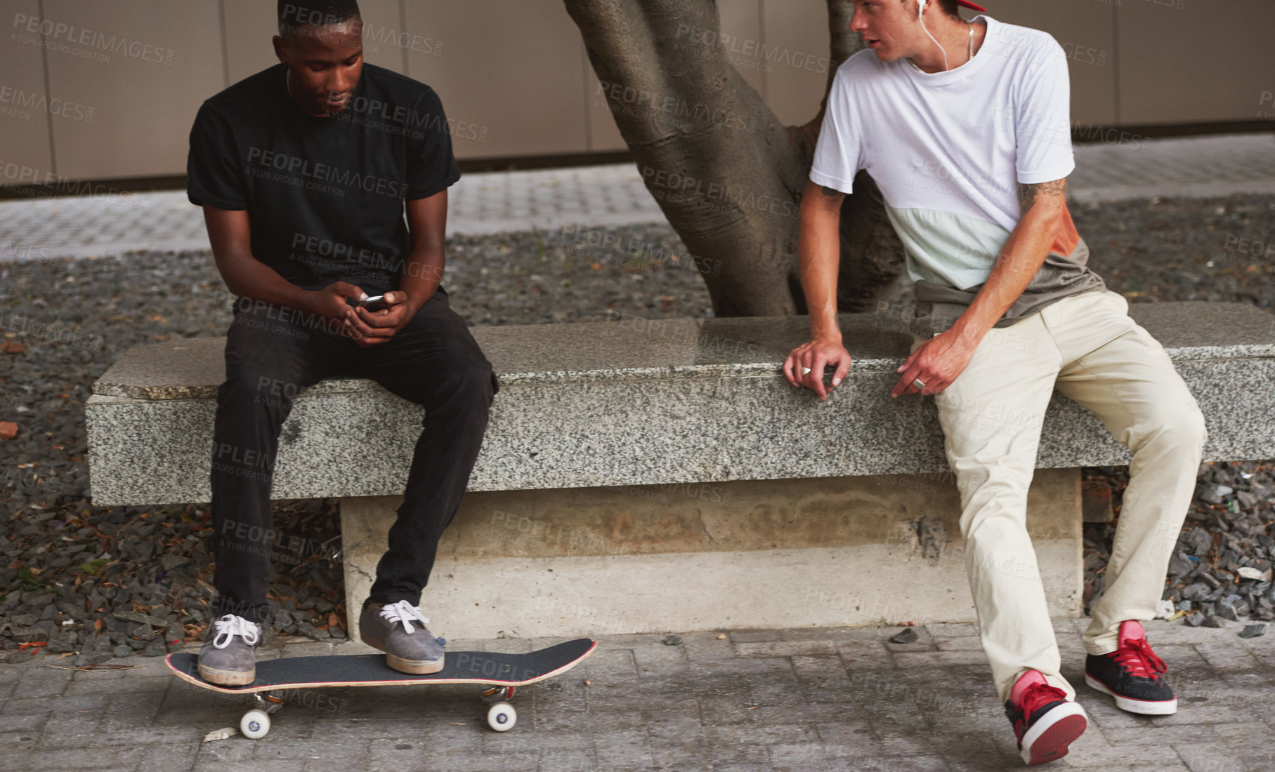 Buy stock photo Shot of two skaters sitting together