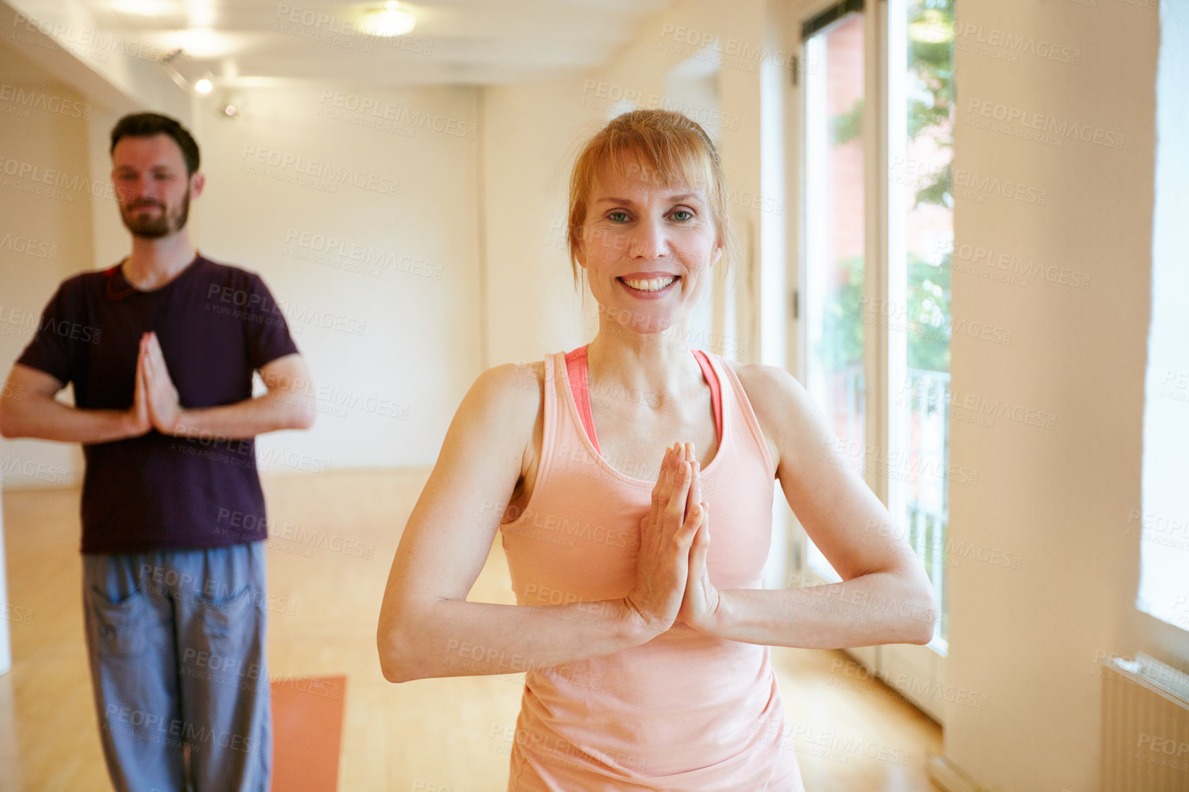 Buy stock photo Shot of two people doing yoga together in a studio