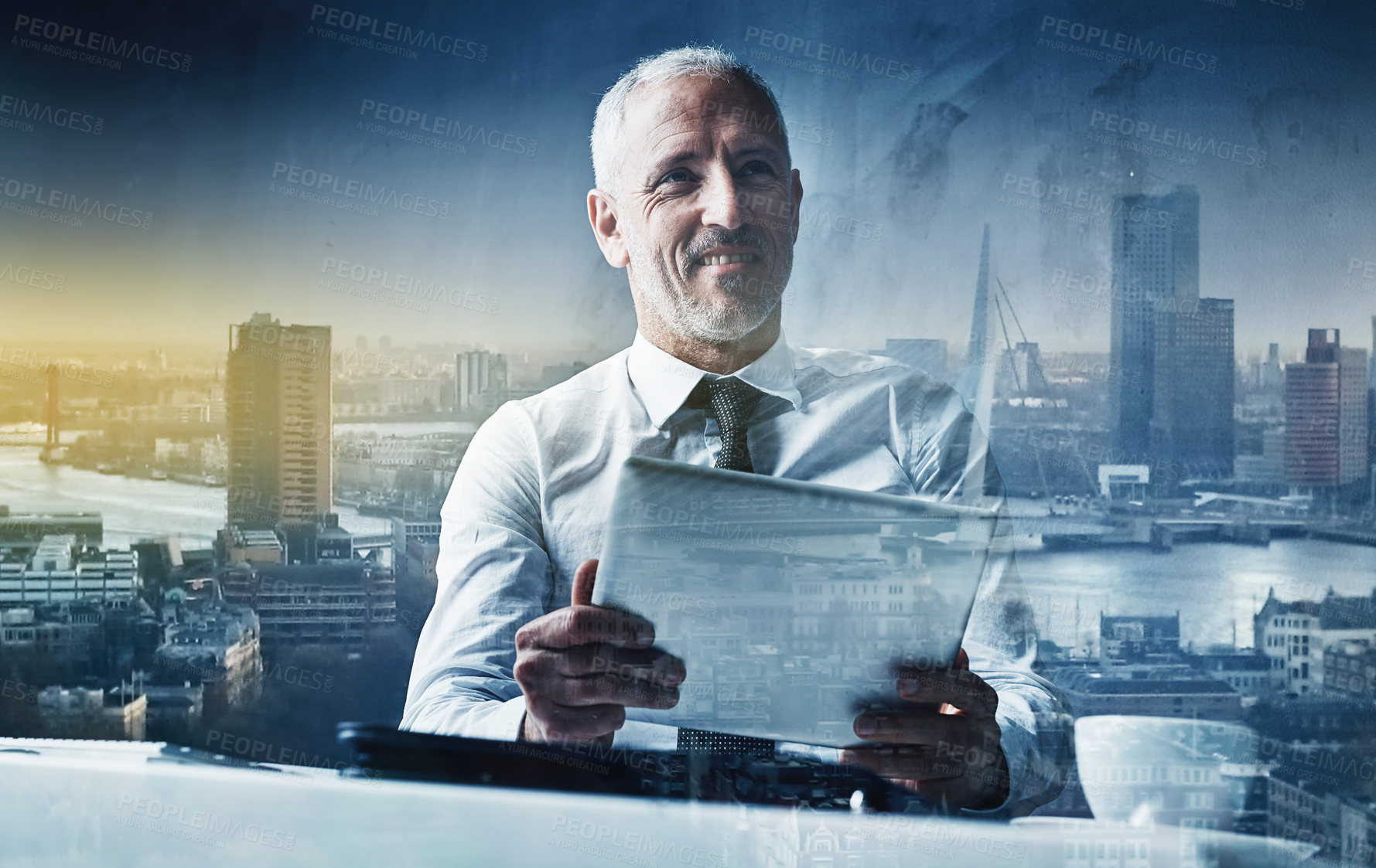 Buy stock photo Shot of a happy businessman using a tablet superimposed over a cityscape