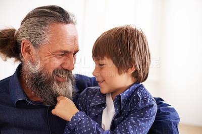 Buy stock photo Smile, grandfather and boy with beard and playing, bonding and relax in living room. Happy family, play and fun with grandpa and pulling facial hair, embrace and caring cuddle with love in lounge