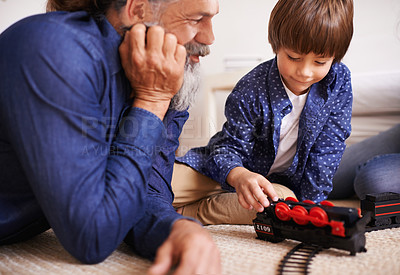 Buy stock photo Grandfather, grandson and play with toy, train and fun in home or house with joy. Man, child and happiness with smile, youth and childhood development for future growth and bonding or care together