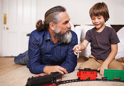 Buy stock photo Father, child and play with toy train and joy in home or house with fun. Mature man, kid and happiness with smile, youth and childhood development for future growth and bonding or care together