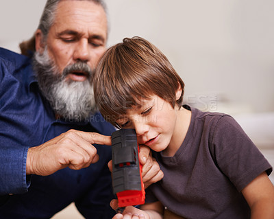 Buy stock photo Grandfather, toy and train with boy child, playing and bonding in family home. Grandpa, young kid and childhood development with games and fun, quality time and love with elderly retired man 