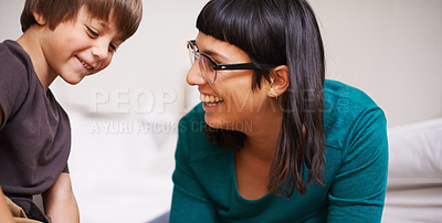 Buy stock photo Shot of a mother and her son sitting on the floor indoors