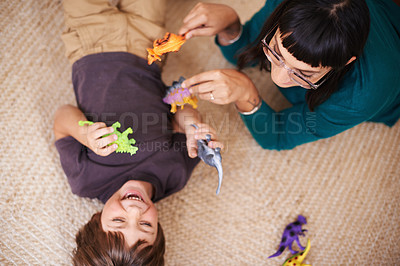 Buy stock photo Woman, kid and toy with dinosaur, carpet and play for joy or fun at family home or house. Mother, child and bedroom with bonding, childhood and future development or growth for high angle happy care
