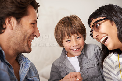 Buy stock photo Family, love and son with laugh in bedroom, support and happy for childhood in home on bed. Parents, child and security in connection or funny joke, care and relax on weekend or fun for bonding