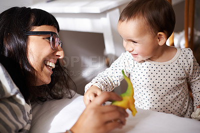 Buy stock photo Mother, love and kid with toy in bedroom, play and happy for childhood in home on bed. Mommy, daughter and security in connection or trust, child development and relax on weekend for bonding