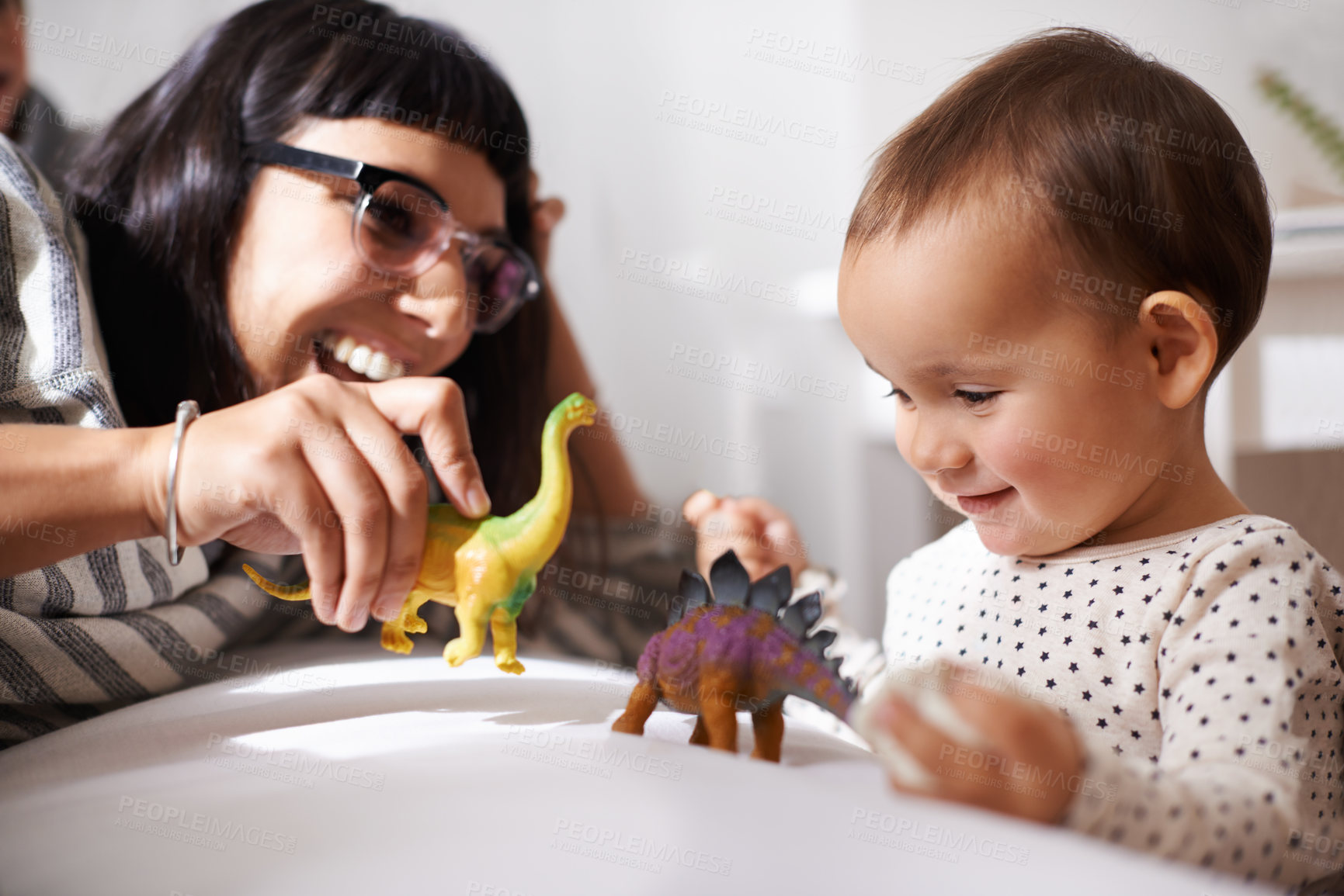 Buy stock photo Shot of a happy mother playing with her daughter and toys