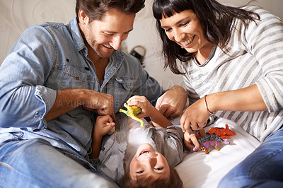 Buy stock photo Happy, family and kid playing in living room together for bonding, having fun and entertainment in home. Childhood development, Australian man and woman with child for laughing, joke and toys