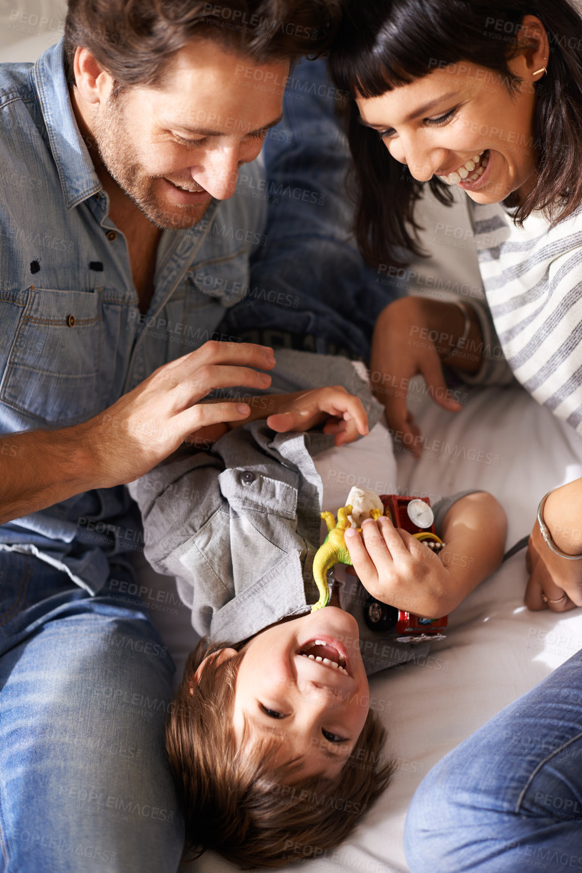 Buy stock photo Cropped shot of happy parents bonding with their son at home