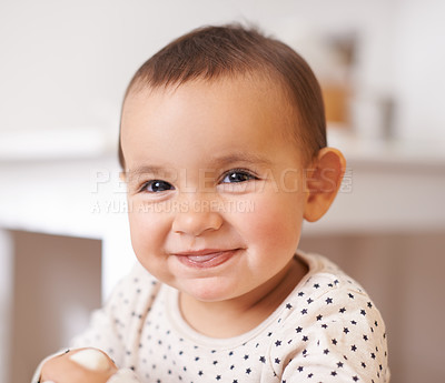 Buy stock photo Baby, toddler portrait and smile in home, childhood and care for enjoyment or fun in bedroom. Girl, kid and happy for child development and relax in nursery, satisfaction and face for humor or silly