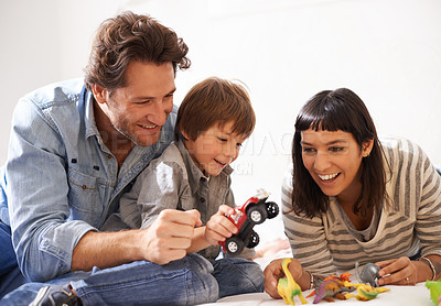 Buy stock photo Happy, family and child playing in living room together for bonding, having fun and entertainment in home. Childhood development, Australian man and woman with boy kid for smile, laugh and toys