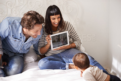 Buy stock photo Family, child and toddler for video call in bedroom, internet and happy for grandparents on screen. Parents, baby and security in connection or laugh, communication and love or online for bonding