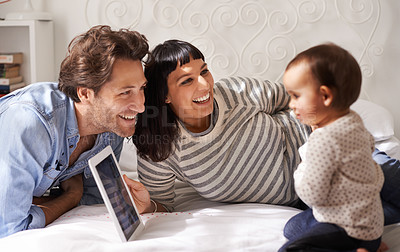 Buy stock photo Parents, toddler and tablet for learning in home, online and happy for education in bedroom. Family, child development and girl for streaming entertainment, website and app for cartoon or movie