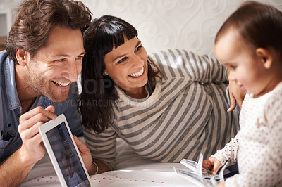 Buy stock photo Parents, toddler and tablet for entertainment in home, online and happy for education in bedroom. Family, child development and girl for streaming on internet, website and app for cartoon or movie