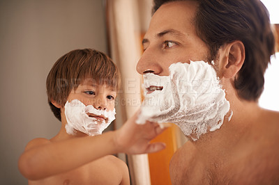Buy stock photo Shot of a little boy helping his father to shave