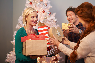 Buy stock photo Friends, Christmas and gift giving at tree for festive season celebration with present, vacation or together. Man, women and parcel event in living room for winter break or excited, bonding or love