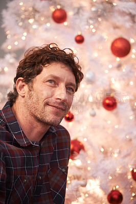 Buy stock photo Man, thinking and Christmas tree for holiday celebration for vacation thoughts, lights or ornaments. Male person, contemplating and festive season for gift giving event for relax, present or idea