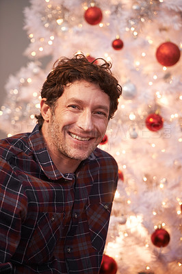 Buy stock photo Portrait, Christmas and man with smile, home and happiness with decorations and festive season. Face, Xmas tree and apartment with celebration and excited with guy and cheerful with lights or person