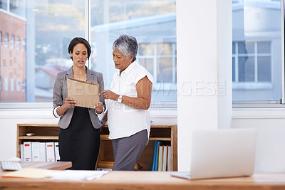 Buy stock photo Business women, paperwork and talking in office for planning, brainstorming or advice. Corporate team or manager and employee together for discussion, collaboration or teamwork on a report or project