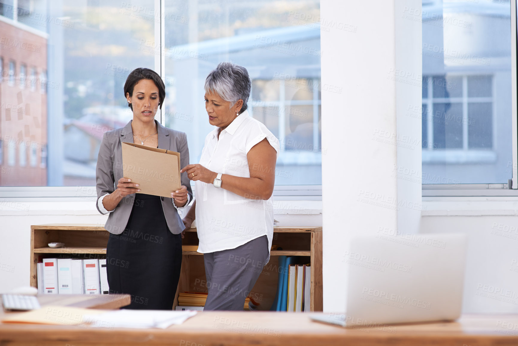 Buy stock photo Business women, paperwork and talking in office for planning, brainstorming or advice. Corporate team or manager and employee together for discussion, collaboration or teamwork on a report or project