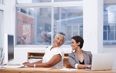 Buy stock photo Office, women and happy conversation together for engagement or fun discussion at desk with laptops for research work. Female employees, speaking and communication for tasks or projects and enjoyment