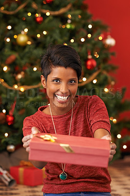 Buy stock photo Christmas, portrait and woman with gift giving for celebration offer and kindness on festive holiday. Smile. person and face with happiness for present, share and special event in living room