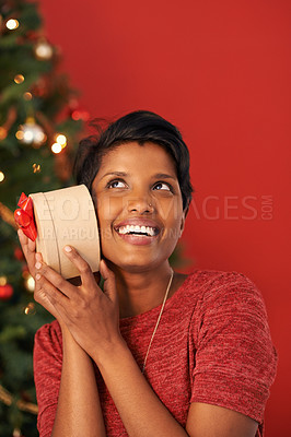 Buy stock photo Christmas, excited and woman guess gift in box at home for holiday celebration on mockup space in India. Happy person, xmas and shaking present or listening to package for festive season in house