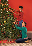 Fitting the Christmas tree with decorations