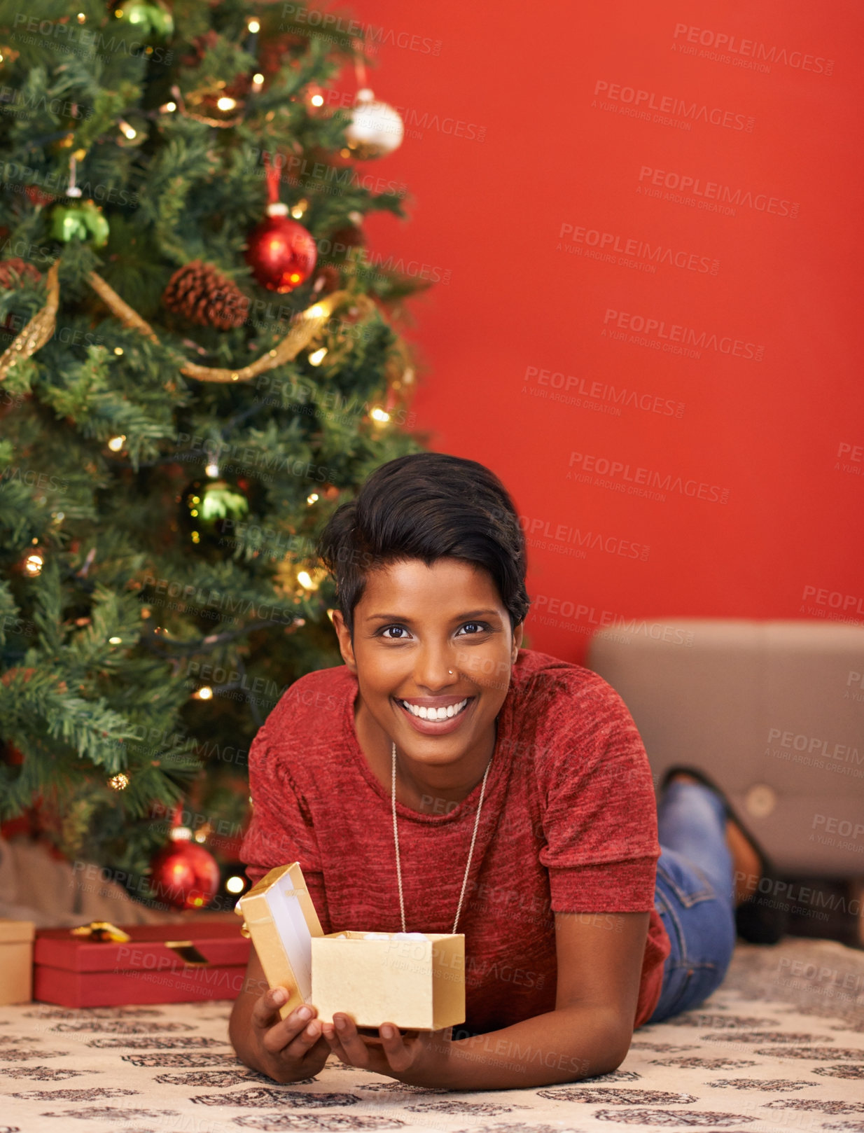 Buy stock photo Christmas, portrait and happy woman open gift on the floor in home in box or package for holiday celebration on mockup space in India. Xmas, face and person with present to relax for festive season