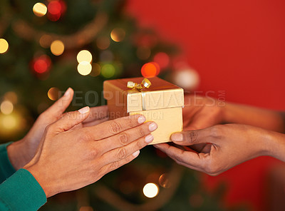 Buy stock photo Closeup, hand or gift at Christmas as love, friends or peace in celebration, gratitude or kindness. People, light or box as thank you, blessing or care as tradition of appreciation and religion