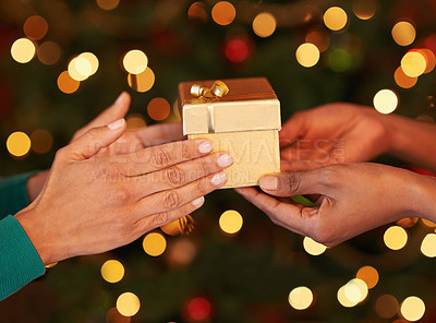 Buy stock photo Shot of two unrecognizable women exchanging gifts at Christmas