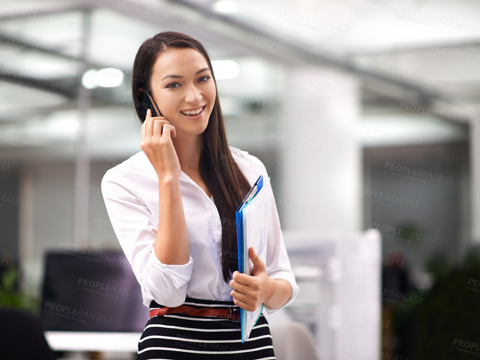 Buy stock photo Portrait of an attractive young woman using her cellphone in the office