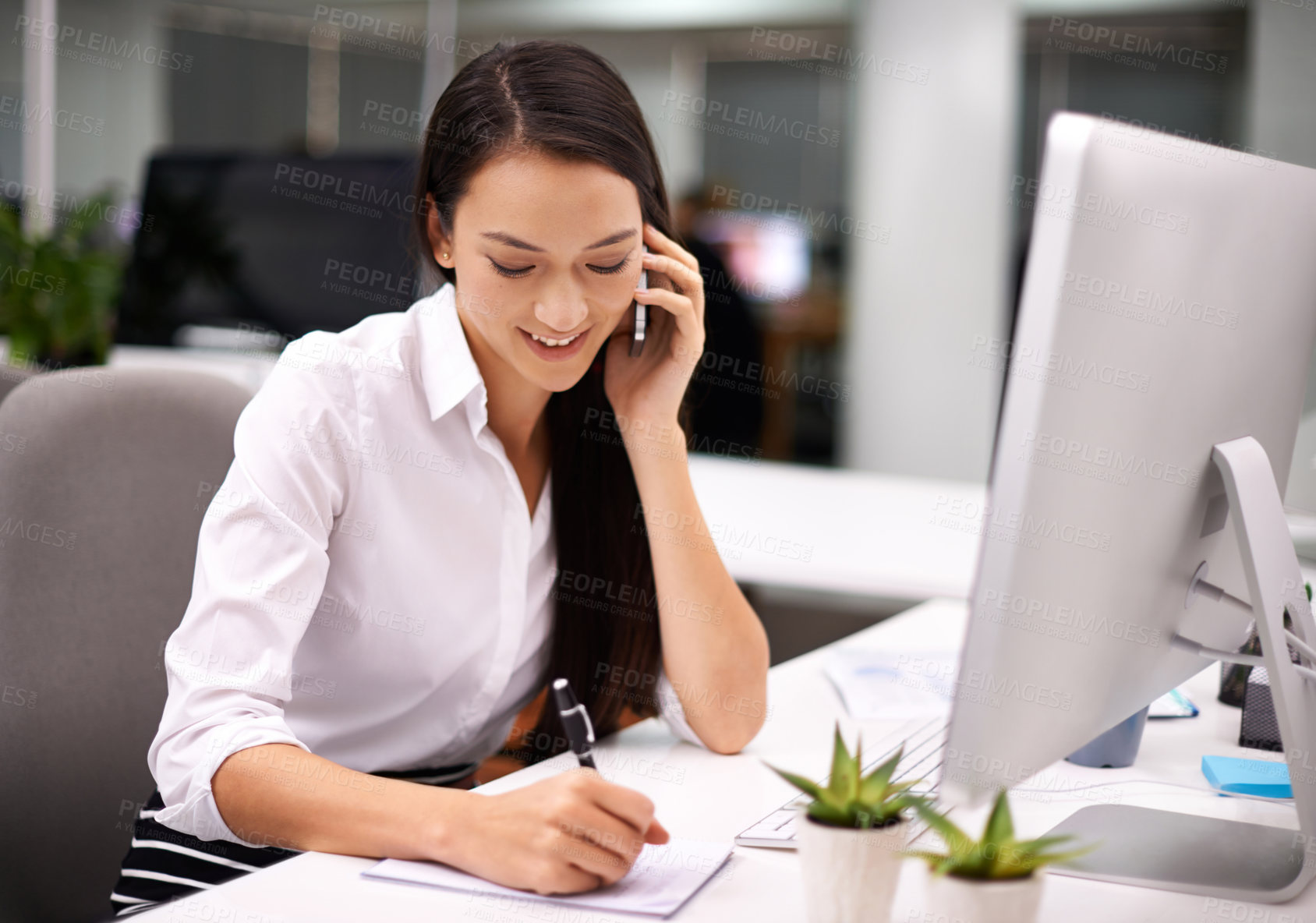 Buy stock photo Cropped shot of an attractive young woman working at her desk