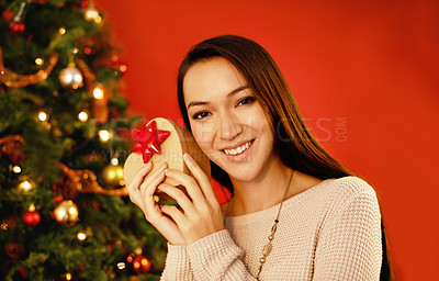 Buy stock photo Portrait, smile and Christmas with woman, gift box and package on a red studio background. Face, person and girl with Xmas parcel and present with surprise and guessing with giveaway prize or holiday