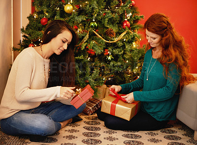 Buy stock photo Christmas, smile and women with presents, tree with decor in living room for holiday. Gift giving, open and family sitting on floor together, Christian celebration on Xmas eve with mother and child 