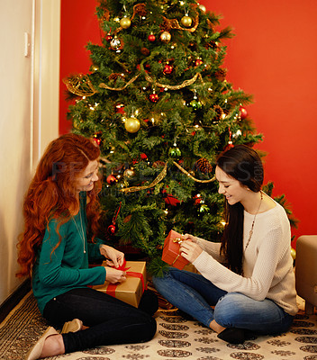 Buy stock photo Christmas, happy and women with presents, tree with decor in living room for holiday. Gift giving, smile and family sitting on floor together, Christian celebration on Xmas eve with mother and child 