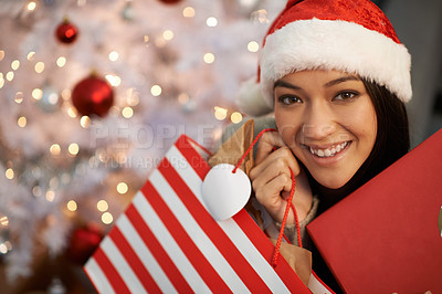 Buy stock photo Portrait of an attractive young woman holding her Christmas gifts