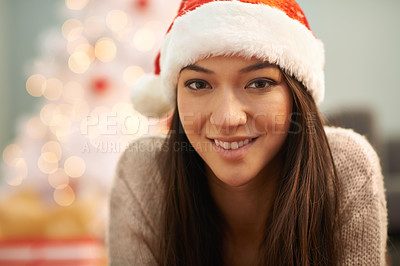 Buy stock photo Portrait, smile and Christmas with santa hat woman in living room of home for festive celebration. Face, confident and evening with happy young person on apartment floor for December holiday season