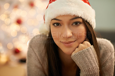 Buy stock photo Portrait of an attractive young woman wearing a santa hat at Christmas