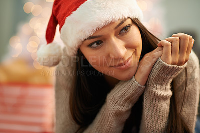 Buy stock photo Christmas, face and thinking with young woman in living room of home for memory or nostalgia. Smile, planning or vision and happy person with Santa hat in apartment for December holiday season