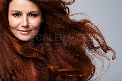Buy stock photo Redhead, wind and hair portrait of woman in studio for treatment, wellness and beauty on gray background. Salon, hairdresser and happy face of female model with shine, healthy and natural hairstyle