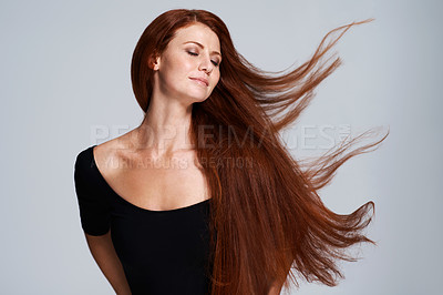Buy stock photo Hair, beauty and woman in studio with wind for keratin treatment, wellness and haircare on gray background. Salon, hairdresser and face of ginger female model for shine, healthy and natural hairstyle