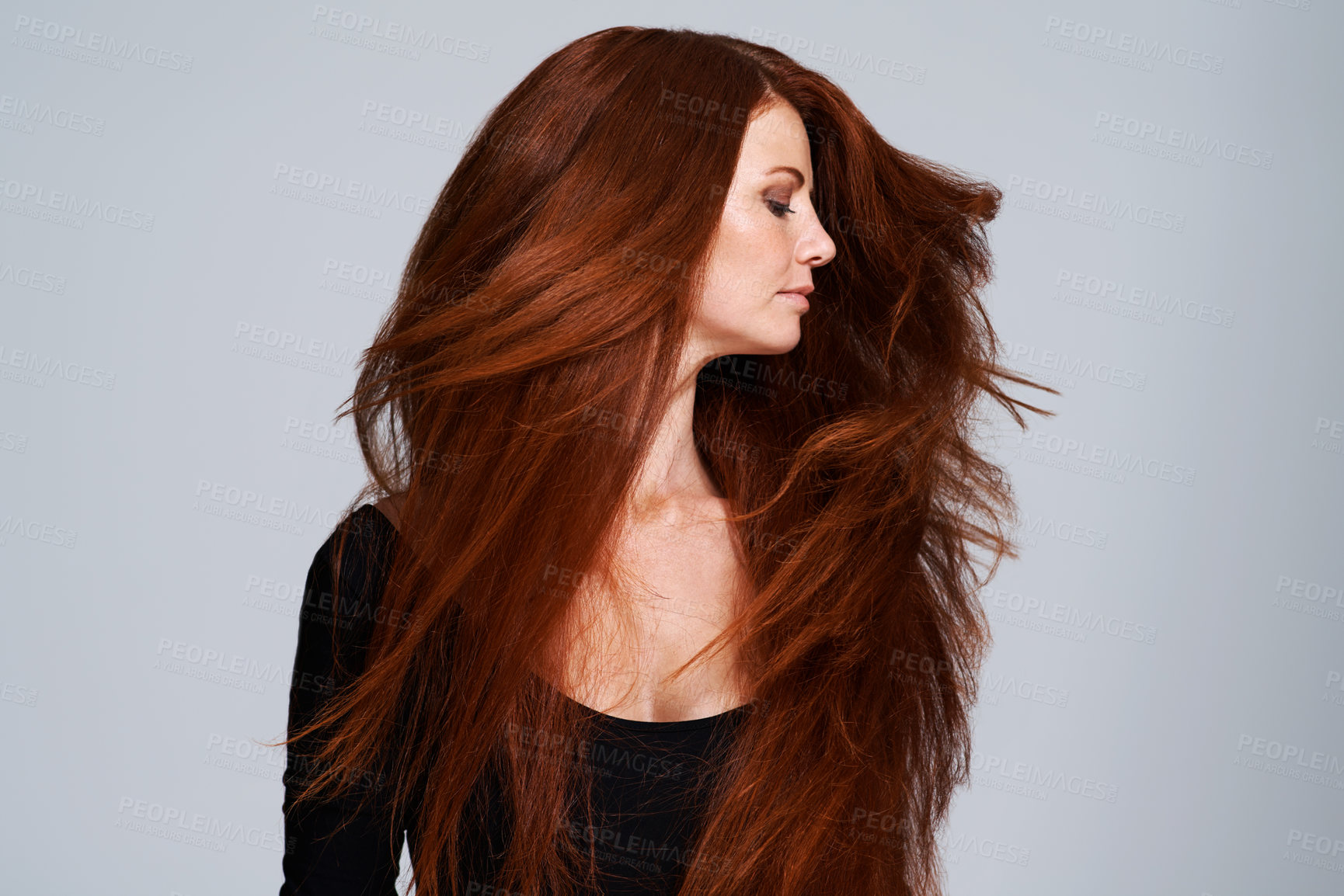 Buy stock photo Red hair, shake and woman in studio for keratin treatment, wellness and haircare on gray background. Beauty, hairdresser mockup and female model with shine, healthy and natural, ginger hairstyle