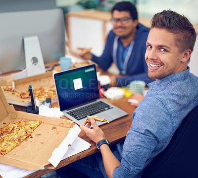 Buy stock photo Businessman, portrait and eating by laptop in office with happiness for lunch break, pizza and coworking company. Programmer, employee and face or smile with fast food, coding team or screen at desk 