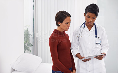 Buy stock photo Shot of a female medical professional explaining a procedure to her patient using a tablet